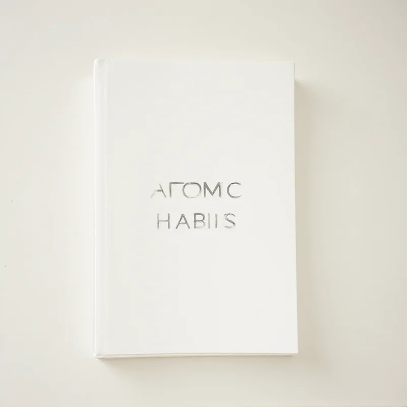 Close-up of the book cover 'Atomic Habits' with a minimalist design and bold typography.